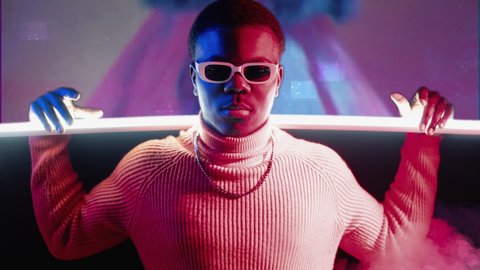 Cyber people. Digital art. Synthwave party. Red blue neon light portrait of confident guy in sunglasses on glitch static noise motion explosion color smoke background.