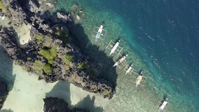 Aerial cinematic sea view of Lagoons in El Nido Palawan in the Philippines with Iconic Philippines Boats