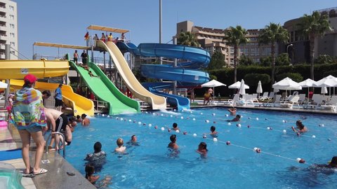 Turkey, Antalya, 24 August-2021. Water slides, water park on the territory of the resort hotel. Adults and children of many nationalities, hotel guests, swim in the pool.