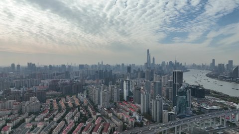 Drone aerial view of Shanghai downtown panoramic view, traffic and Huangpu river and the city. Business, travel and economy concept b-roll footage. Sky and the skyscraper of Lujiazui District far away