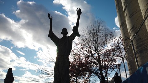 Toronto , ON , Canada - 11 10 2021: Symbolic Jubilant Man statue reaches for the sky with outstretched arms