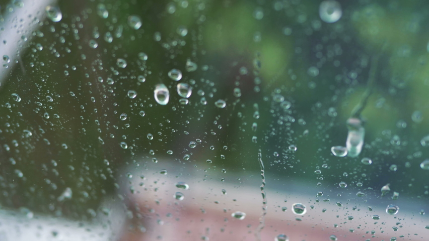 Rainy day behing the window in 4k slow motion 60fps