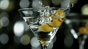 Super slow motion of falling olives into cocktail drink, camera movement. Filmed on high speed cinema camera, 1000 fps. - Powered by Shutterstock - Get 15% off with code: PIKWIZARD15