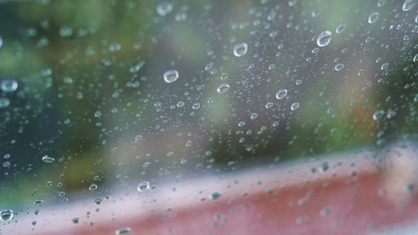 Rainy day behing the window in 4k slow motion 60fps