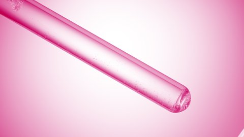 Lactic acid is injected in test tube with clear liquid creating bubbles on pale pink background | Abstract body care cosmetics with lactic acid formulating concept
