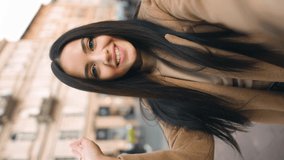 Vertical orientation portrait of cheerful brunette young woman looking at camera and talking recording vlog.  POV of cute young lady making online video call looking at camera. - Powered by Shutterstock - Get 15% off with code: PIKWIZARD15