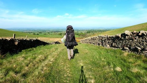High Cup Nick. Cumbria. England. June. 2. 2021. Backpacker hiking walking forward away from the camera