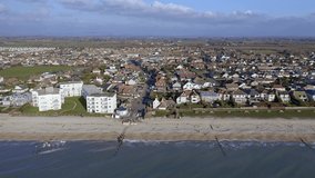 Aerial along the seafront of East Wittering, a seaside village in Southern England and popular with tourists in the summer.