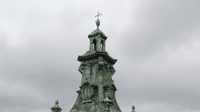 Aerial drone view of Latin Cathedral church dome in city Lviv, Ukraine. Traditional old famous sobor. Flight above roofs, streets. Cloudy day sky background. 4K UHD footage video. Copy-space. Outdoors