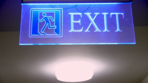 exit sign. exit icon. close-up. sign with the inscription exit, with blue backlight.
