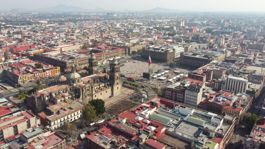 Mexico City: Aerial view of capital city of Mexico, Mexico City's main square Plaza de la Constitucion (El Zócalo) and Metropolitan Cathedral - landscape panorama of North America from above Royalty-Free Stock Footage #1084476079