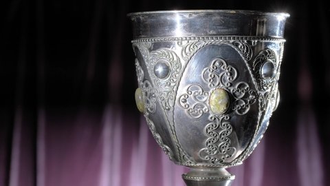 Close-up of old decorated silver bowl and strobe light in the background