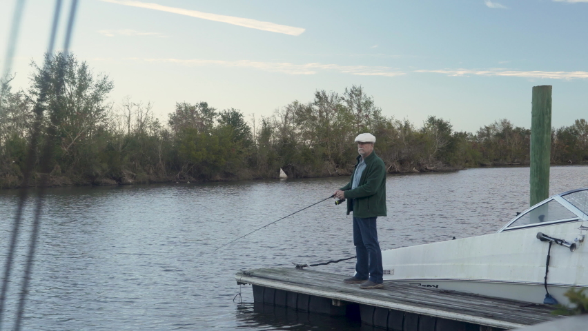 Fishing off a small dock an older adult enjoying some relaxing recreational time important for mental health.