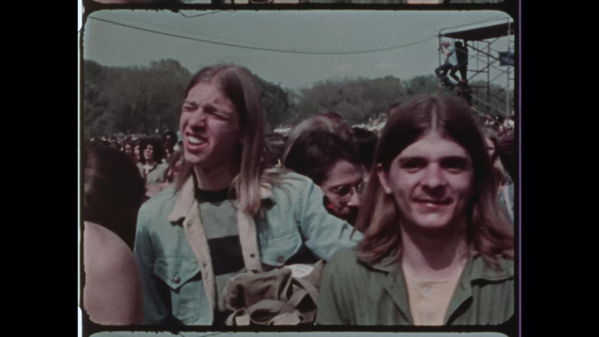 1971 Washington, DC. Hippies assemble below the Washington Monument during the 1971 May Day Protest. 4K Overscan of Vintage Archival 16mm Newsreel