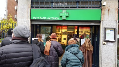 Europe, Italy , Milan December 2021 - 
long line queue of people outside the pharmacy waiting to take the rapid test swab against Covid-19 Coronavirus epidemic, Omicron variant, increase in infections
