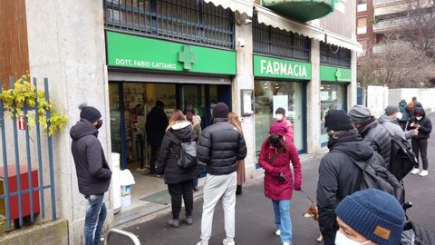 Europe, Italy , Milan December 2021 - 
long line queue of people outside the pharmacy waiting to take the rapid test swab against Covid-19 Coronavirus epidemic, Omicron variant, increase in infections