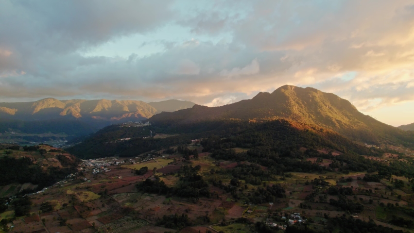 Drone Aerial View Of Golden Hour Sunset Over Imploded Guatemalan Volcano and Countryside Valley. Volcan de Cerro Quemado, Quetzaltenango Xela Guatemala. Royalty-Free Stock Footage #1084497379