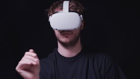 Man With VR Goggles Experiencing 3D Content. Professional Virtual Reality Headset Works and Gestures in Augmented Reality - Steady Shot - Powered by Shutterstock - Get 15% off with code: PIKWIZARD15