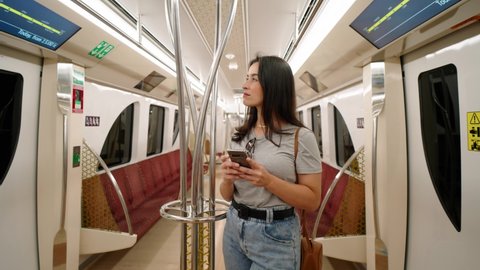 Woman tourist in subway train in Doha Qatar
