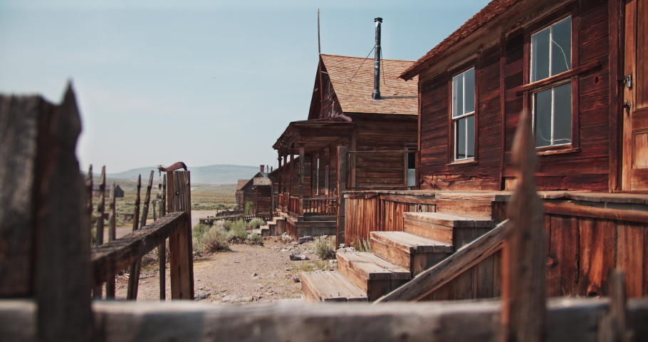 Abandoned Ghost Town with Water Tower. shot moves from a tree and ...