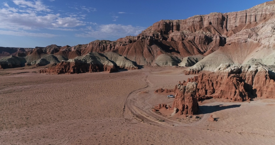 Retro camper parked in a remote area near Goblin Valley State Park, Utah, aerial drone shot