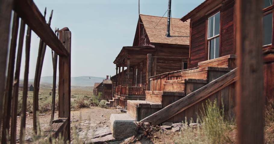 Old wooden historic building with birds nesting in the roof in a ghost town, Bodie California