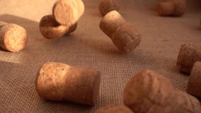 Champagne wine corks fall onto the burlap. Slow motion. - Powered by Shutterstock - Get 15% off with code: PIKWIZARD15