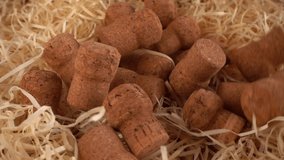 Champagne wine corks fall on the straw. Slow motion. - Powered by Shutterstock - Get 15% off with code: PIKWIZARD15