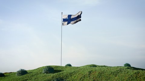 Finland,  Finnish flag waving in the wind on a beautiful landscape. Blue sky. 4K HD. Stunning image.