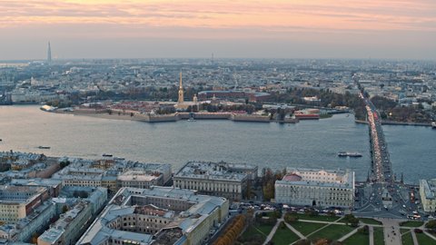 Aerial view of Saint Petersburg city in sunset. Peter and Paul fortress Golden spire weather vane angel. Tourist ships sail on the Neva river.