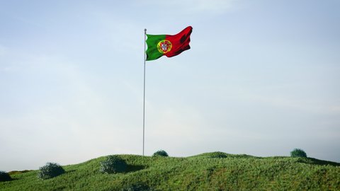 Portugal, Portuguese flag waving in the wind on a beautiful landscape. Blue sky. 4K HD. Stunning image.