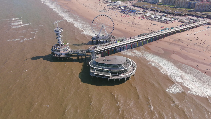 The Hague: Aerial view of Scheveningen Beach in city Hague (Haag), Scheveningen Pier and famous Ferris wheel SkyView de Pier, North Sea in summer - landscape panorama of Netherlands from above, Europe