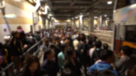 Blurred defocused view of crowd tourists people stand and wait in long queue for ride the bus in Towards Victoria Peak of Hong Kong. Famous sightseeing attraction in rush hour time night