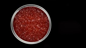 Red caviar in jar top view, rotate. Lots of red caviar. Place for text. 4K UHD video