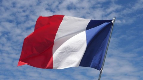 France Flag Waving in the Wind in Slow Motion Close Up with blue sky background. High quality 4k footage