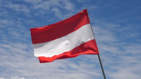 Austrian Flag Waving in the Wind in Slow Motion Close Up with blue sky background. High quality 4k footage