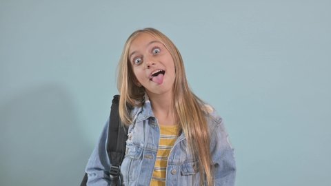 Teen girl making humorous gestures and sticking her tongue out at the camera.