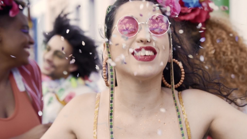 Happy woman dancing at street party of Brazilian Carnival. Slow motion confetti throw | Shutterstock HD Video #1084532848