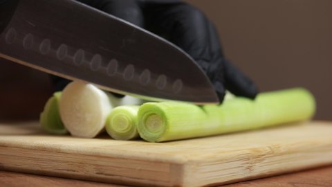 cutting leeks with chef's knife and preparing them for eating