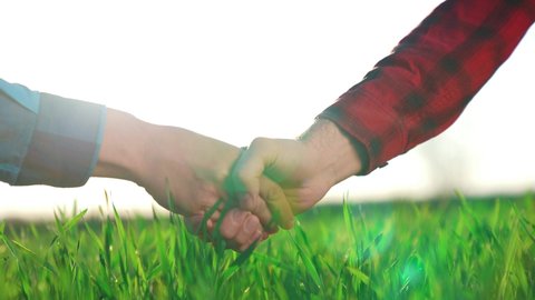 handshake agriculture. hands of group farmer business make a contract in the field. farmer handshake hands shaking hands on green field background market. business agriculture crop concept.