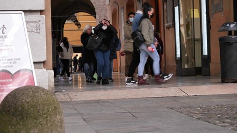 
People walking in central Modena. Modena, Italy - 09 December 2021