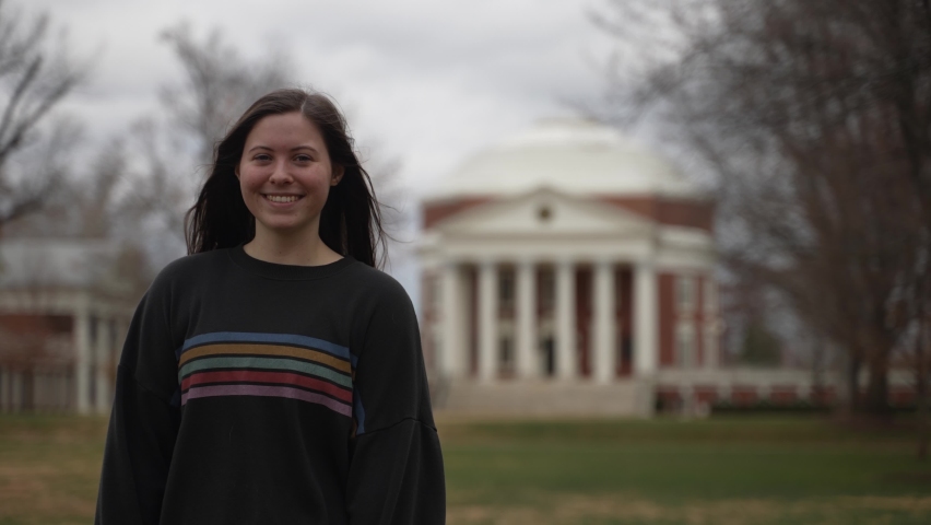 Portrait of a young teen female student at a university or college in Charlottesville, VA in front of the rotunda designed by Thomas Jefferson.
