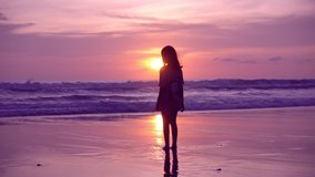 Silhouette Asian teen girl 6 years old jumping on beach at sunset raising arms on beach enjoying Amazing sunset or sunrise on summer travel vacation holiday Happiness travel and bliss concept video