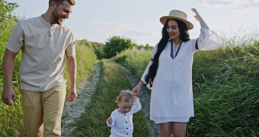 Happy family walking on countryside road Royalty-Free Stock Footage #1084544710