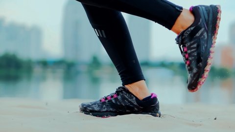 Fitness Girl Running Exercise. Runner Woman Runs In Park. Legs Jogging In Sport Shoes. Jog Dynamic Movement In Sportswear. Professional Female Athlete. Fit Healthy Woman Running Workout. Run On Sand
