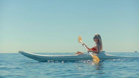 Girl In Kayak Summer Trip. Woman Exploring Calm Sea By Canoe On Holiday Vacation Weekend. Pretty Woman Workout Kayaking On Sea At Summer And Holds Oar. Girl Traveler Swim In Kayak Boat In Tranquil Sea