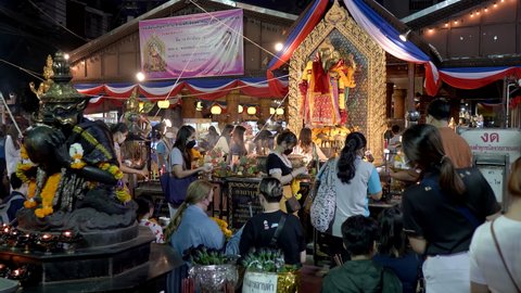 Many Asian young man and women praying to Ganesh, Trimurti and Rahu God for love and success. People Holding joss sticks at Ganesh temple Shrine, Huai Khwang, Bangkok, Thailand 15 Nov 2021