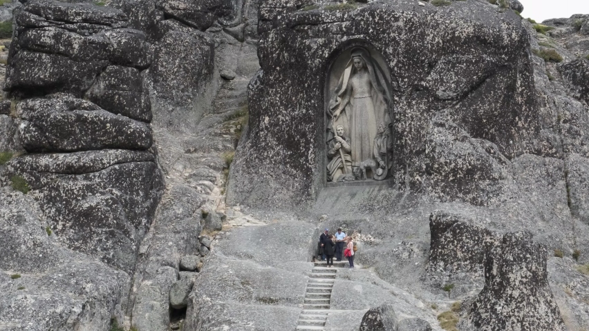 Tourists visit Lady of Good Star worshiping the stone statue.