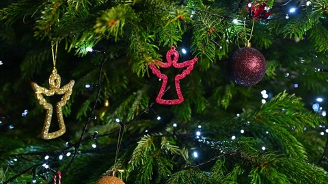 Christmas decorations on a Christmas tree (fir), Christmas tree lights blinking, angel