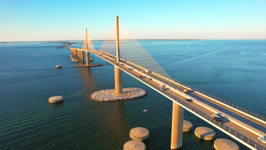 Sunshine Skyway Bridge spanning the Lower Tampa Bay and connecting Terra Ceia to St. Petersburg, Florida, USA. Day video. Ocean or Gulf of Mexico seascape. Reinforced concrete bridge structure. Royalty-Free Stock Footage #1084552927